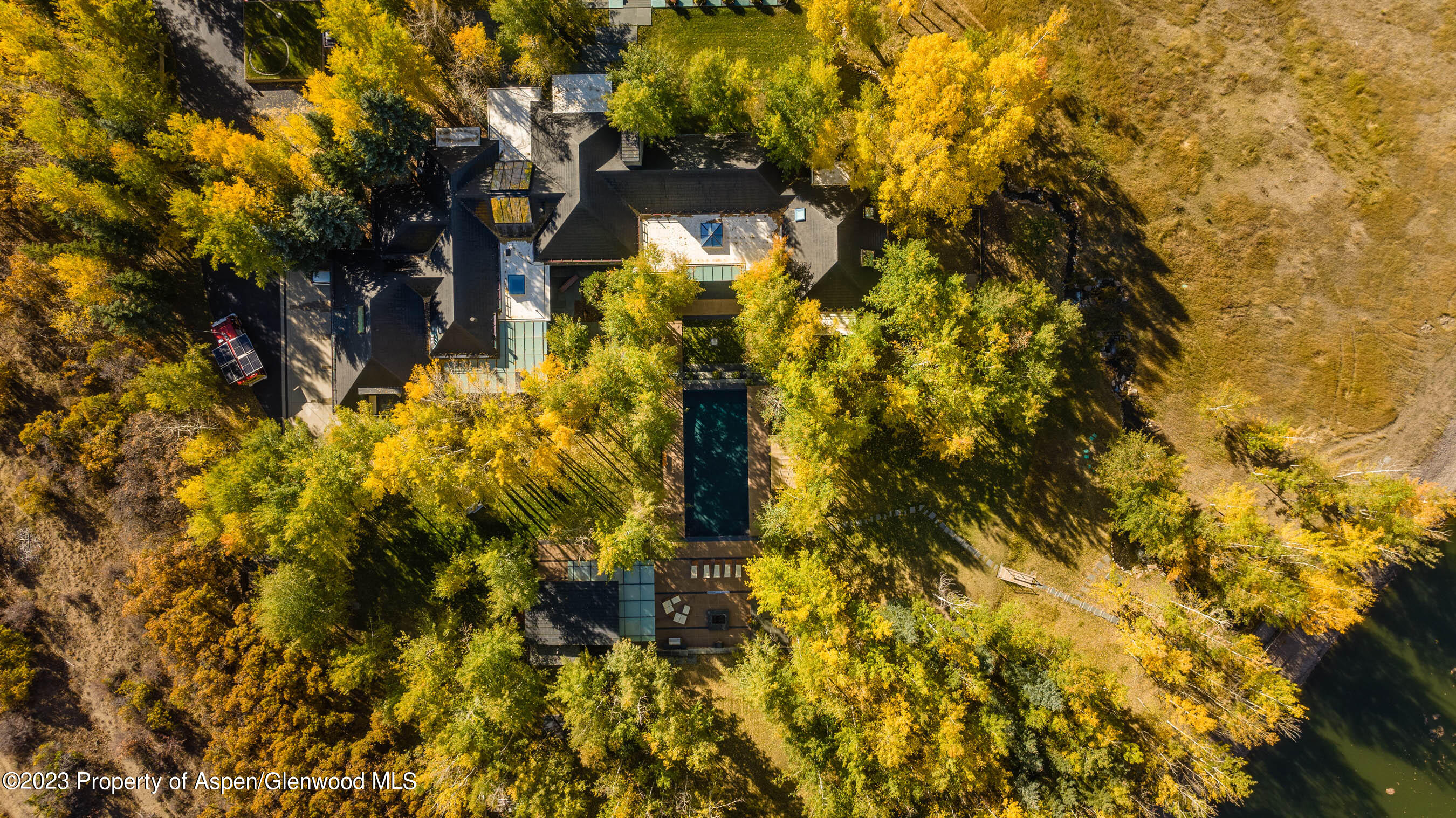 600 Owl Creek Ranch Road Aspen, CO 81611 - Photo 84 of 84 a yellow building with trees in front of it