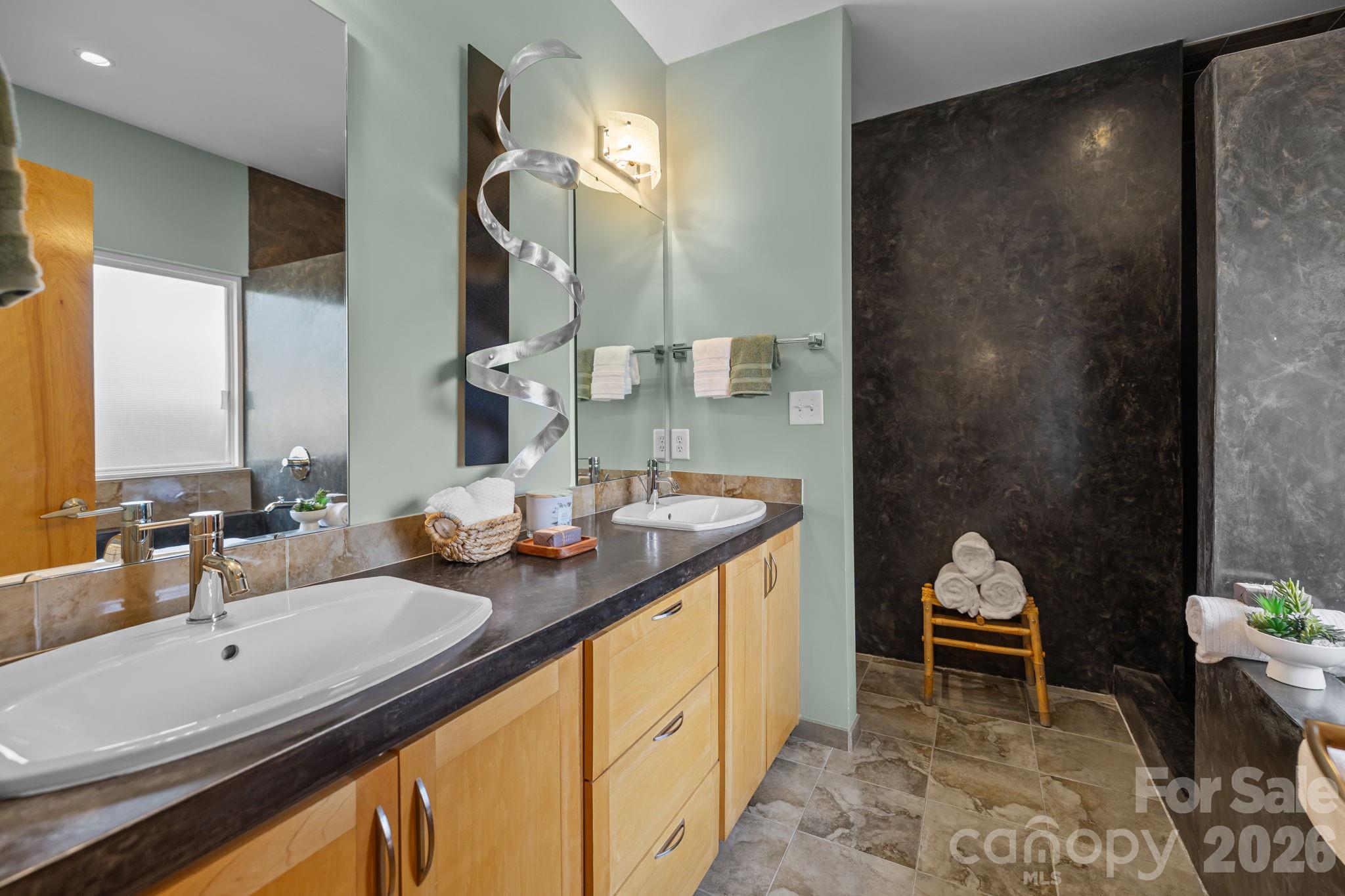 3534 Card Street Charlotte, NC 28205 - Photo 12 of 24 a en suite bathroom with a double vanity sink and a mirror