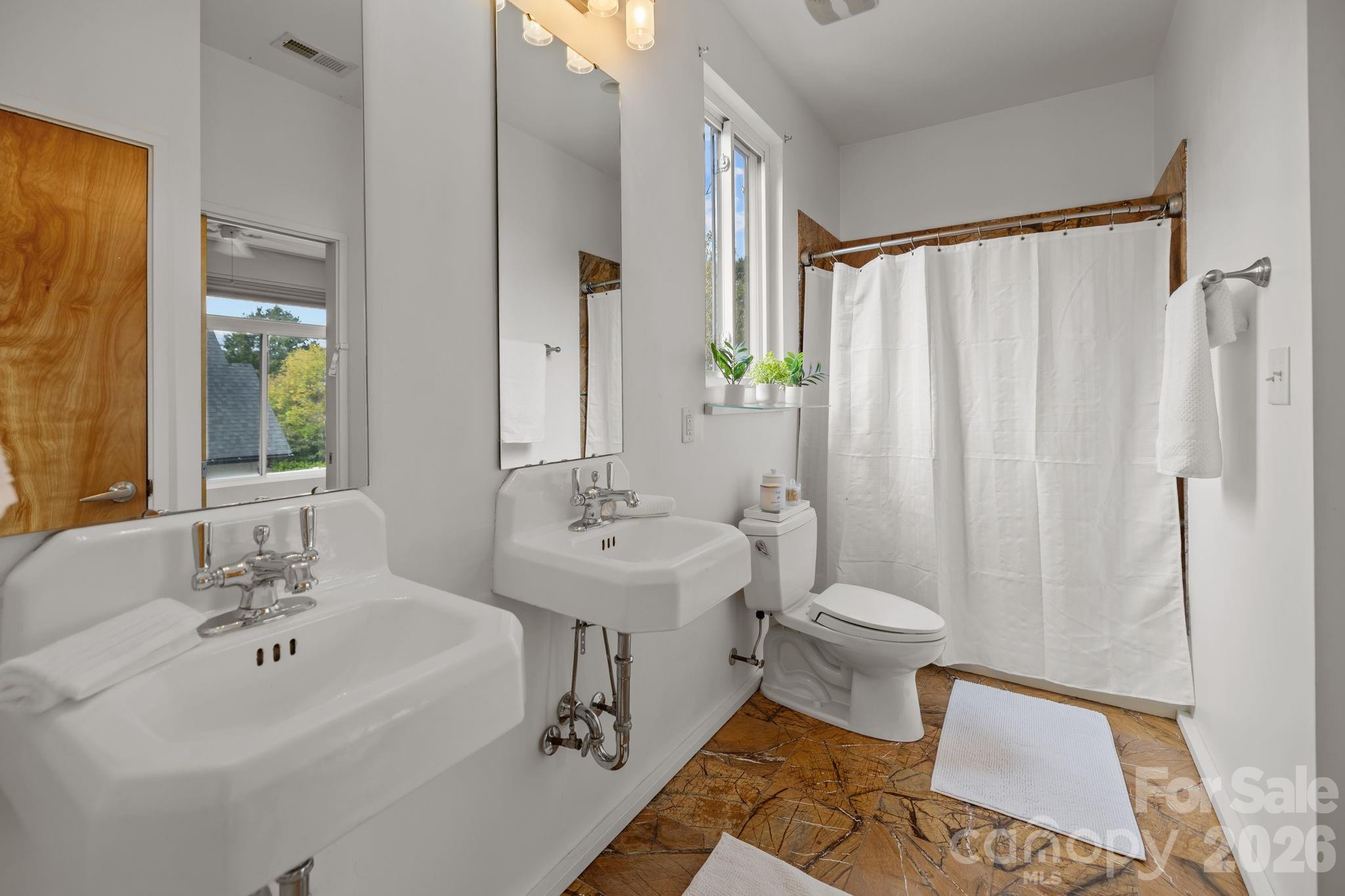 3534 Card Street Charlotte, NC 28205 - Photo 20 of 24 a bathroom with a sink toilet and shower