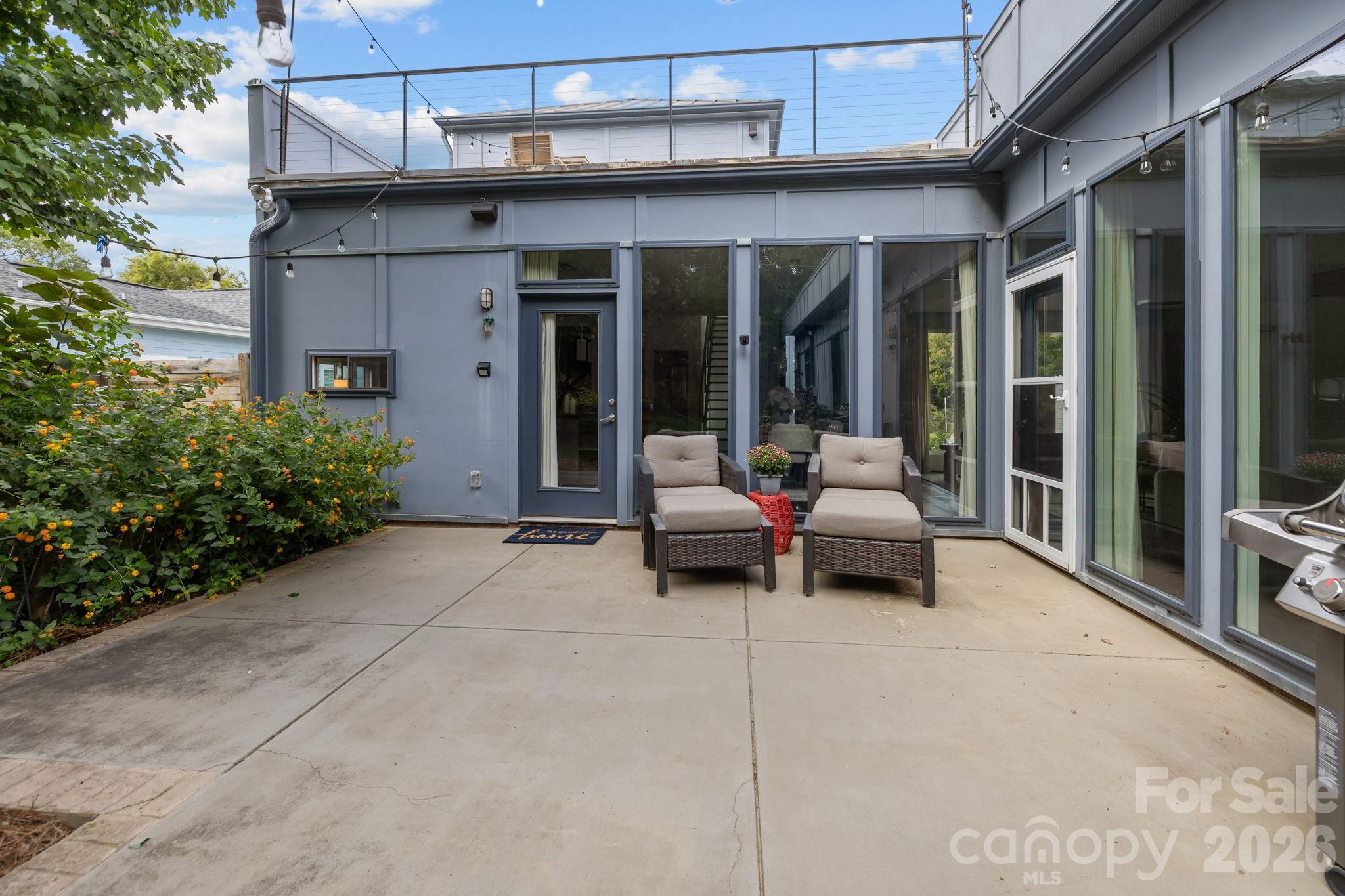 3534 Card Street Charlotte, NC 28205 - Photo 23 of 24 a patio with a table and chairs and potted plants