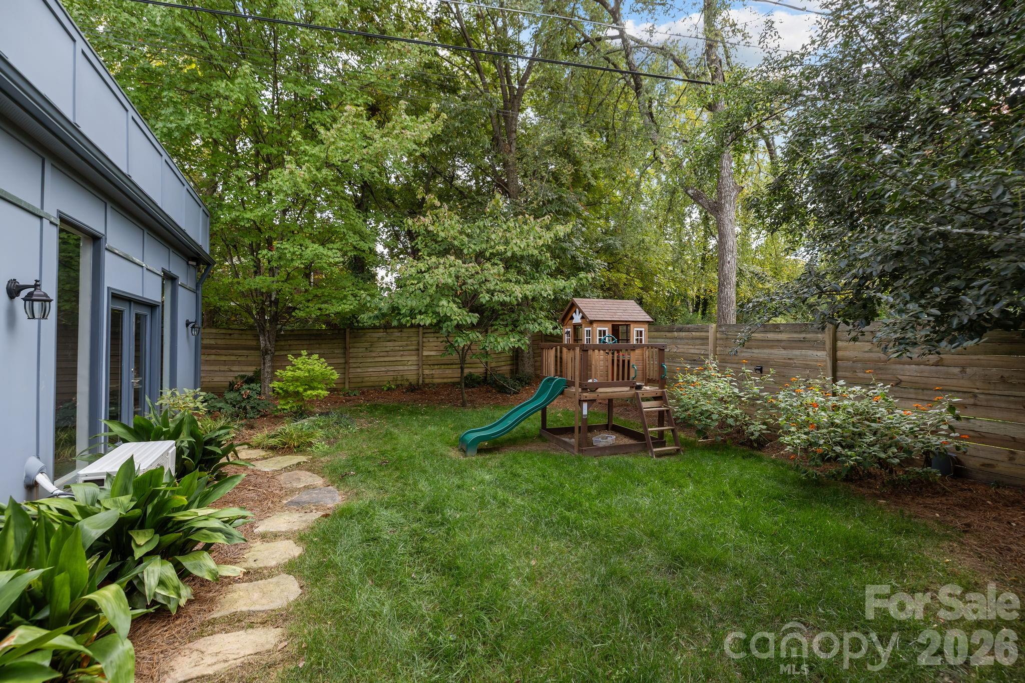 3534 Card Street Charlotte, NC 28205 - Photo 24 of 24 a view of a backyard with plants and a slide