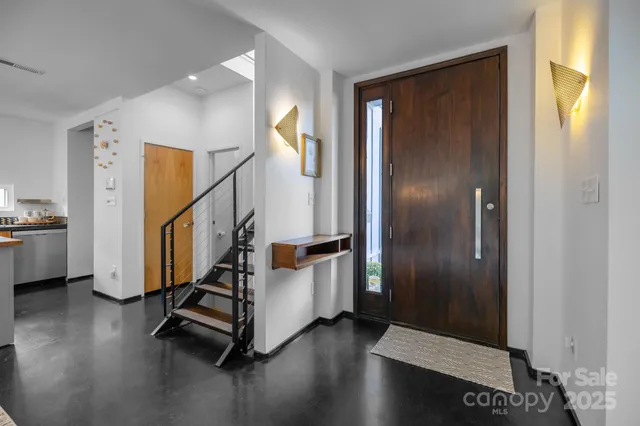 a view of entryway with wooden floor and stairs