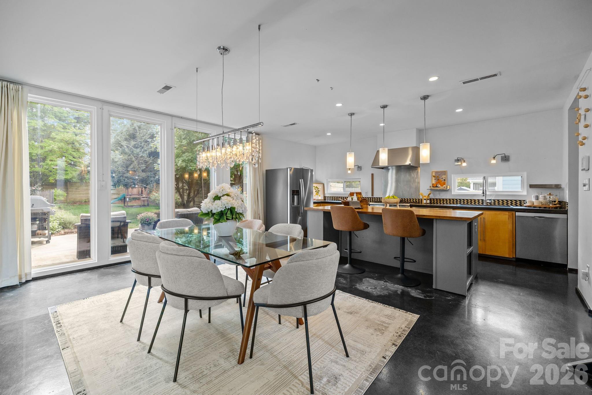 3534 Card Street Charlotte, NC 28205 - Photo 5 of 24 a view of a dining room with furniture a chandelier and wooden floor