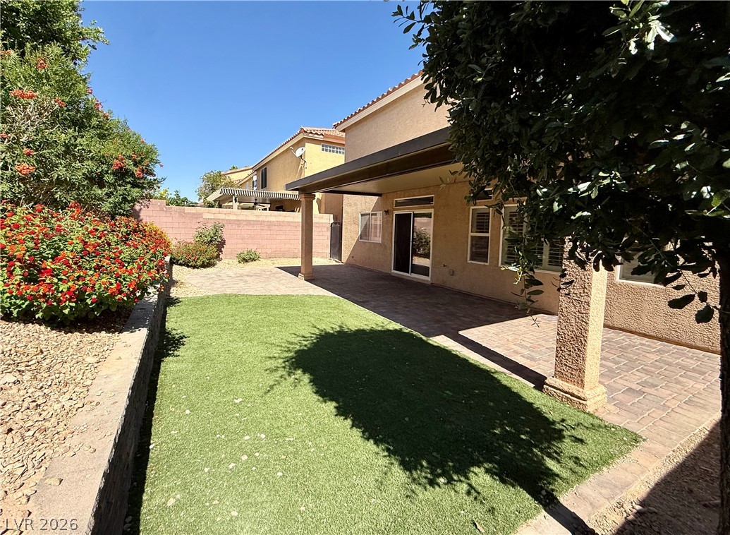 6459 Parrot Ridge Court Las Vegas, NV 89139 - Photo 21 of 23 Enjoy outdoor living with a spacious patio area and vibrant landscaping.