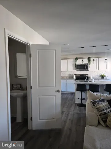 a kitchen with stainless steel appliances kitchen island granite countertop a refrigerator and a stove top oven