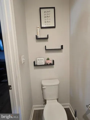 a white toilet sitting next to a sink