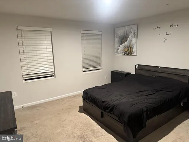 a bedroom with bed and window