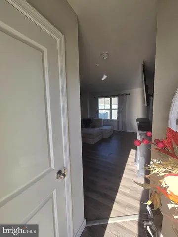 a view of a livingroom with wooden floor and window
