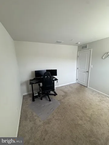 a living room with furniture and a piano