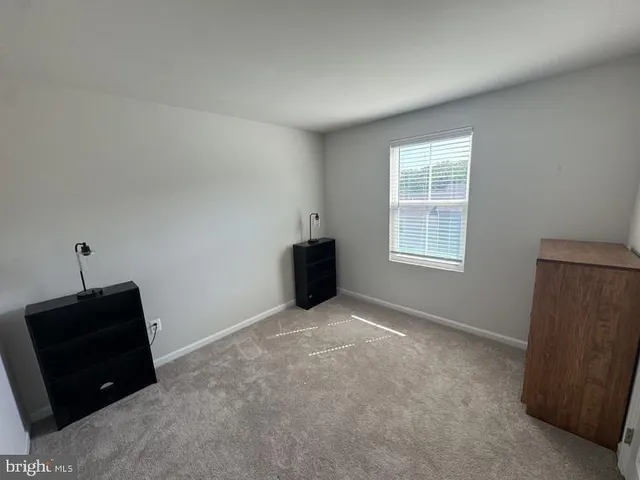 an empty room with a window and closet