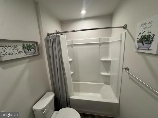 a bathroom with a shower and a toilet