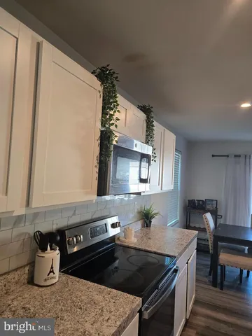 a kitchen with a stove a sink and a microwave