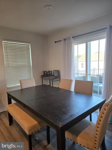 a view of a workspace with a table and chair in the room