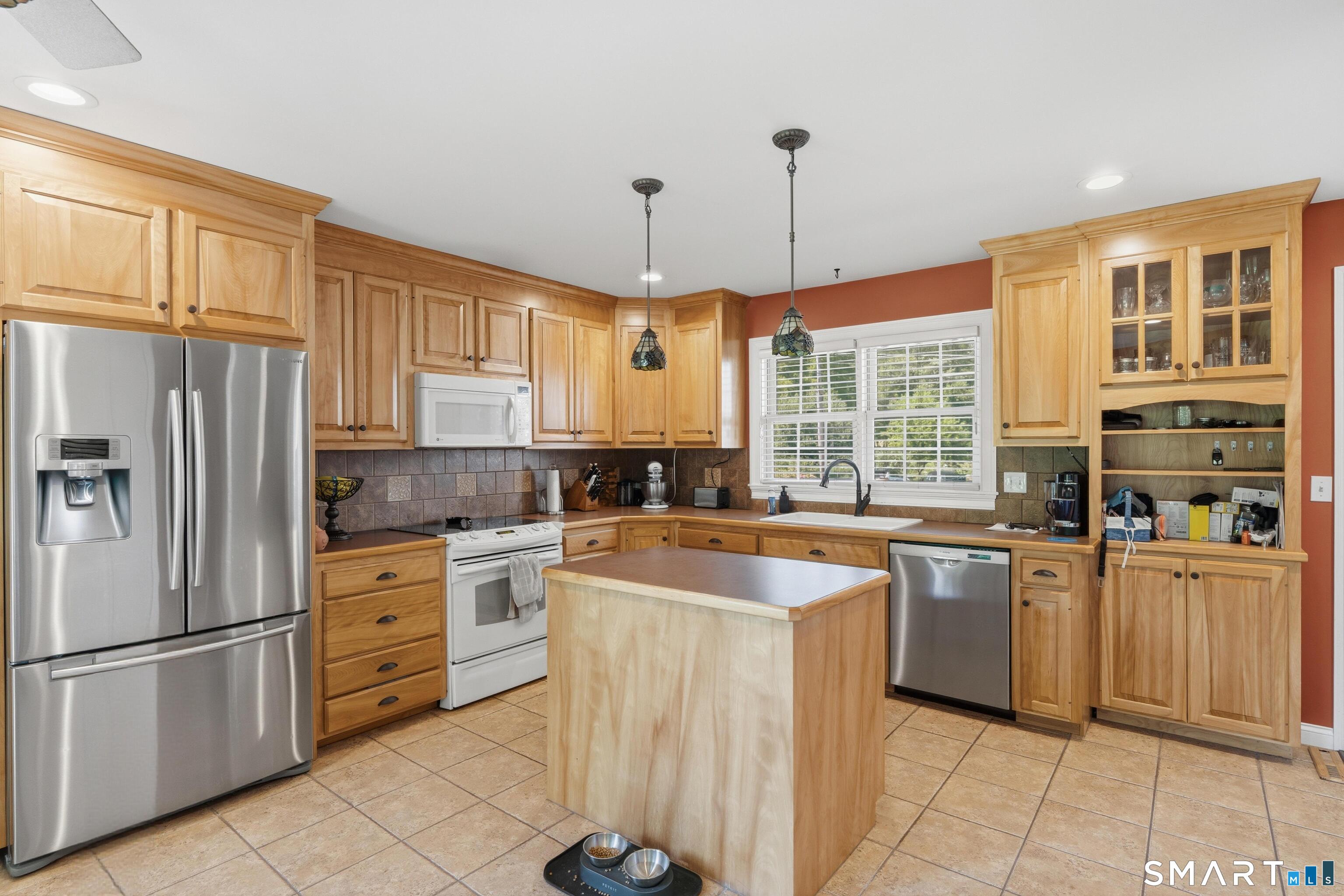 48 Case Road Burlington, CT 06013 - Photo 7 of 39 a kitchen with stainless steel appliances granite countertop a stove a sink dishwasher a refrigerator and white cabinets with wooden floor