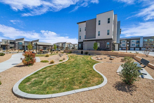 5898 Jasper Rdg Drive St. George, UT 84790 - Photo 39 of 41 Modern multi-story residential building featuring clean architectural lines and a light gray exterior with contemporary window placement