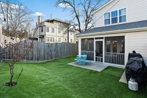 a view of a chair and table in backyard of the house