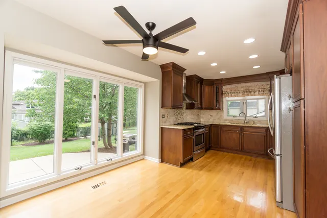 a kitchen with stainless steel appliances granite countertop a refrigerator sink and stove