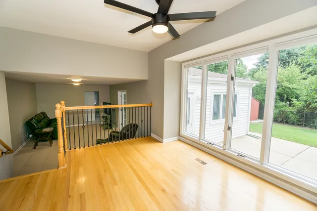 a view of a room with wooden floor and windows