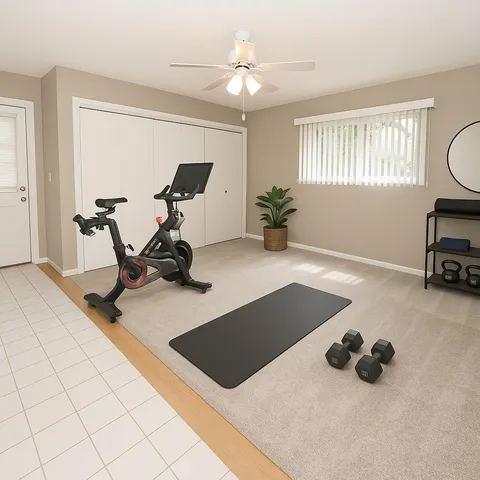 a room with gym equipment and view of living room