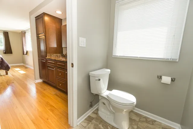 a bathroom with a toilet sink and a mirror