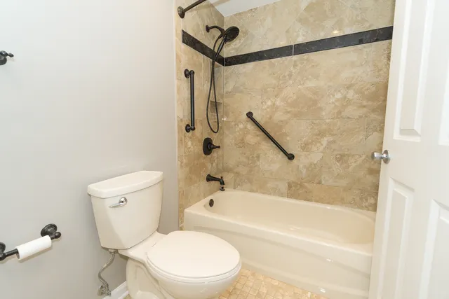 a bathroom with a toilet and a shower