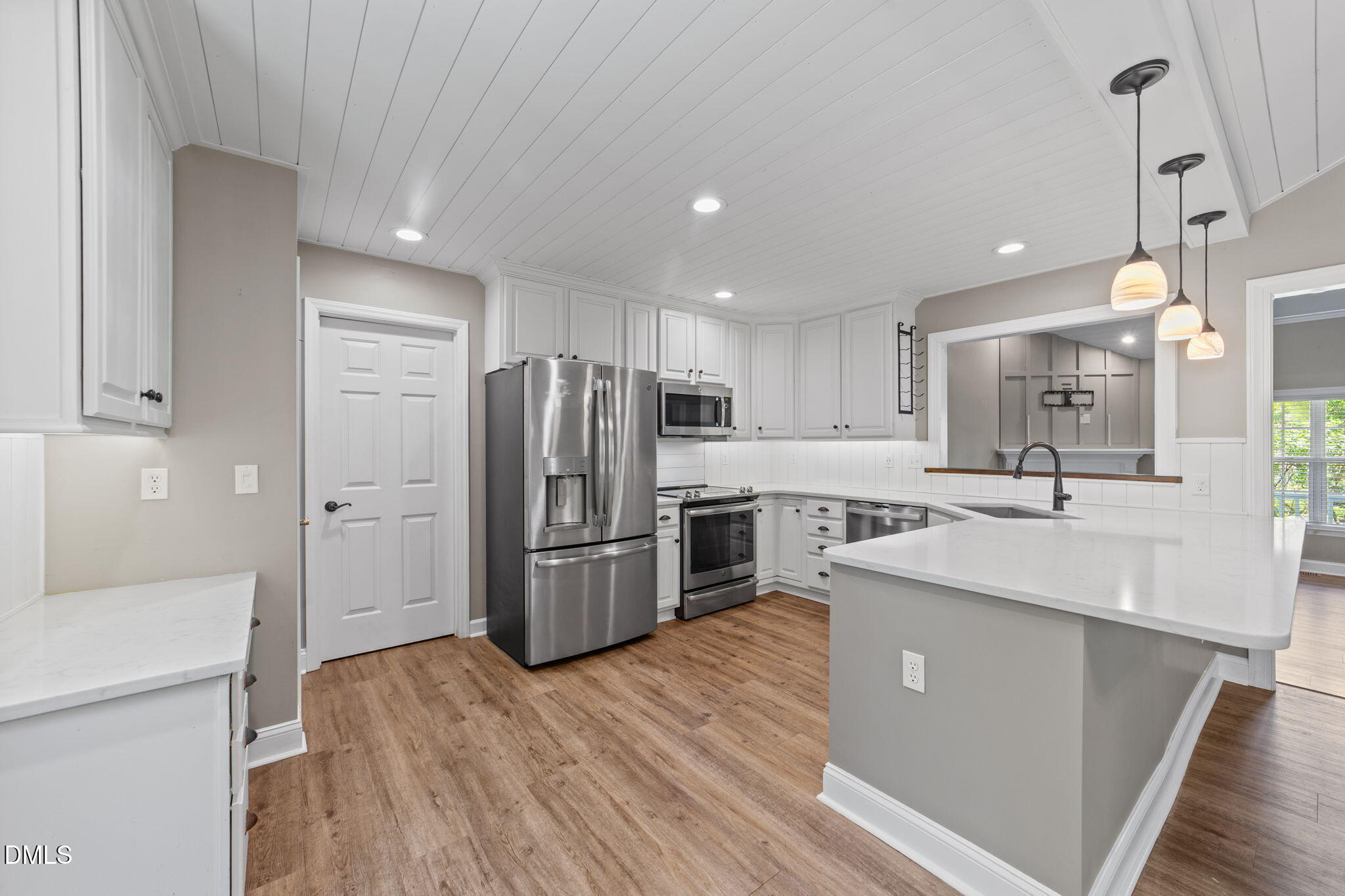 6820 Oviedo Drive Raleigh, NC 27603 - Photo 13 of 50 a kitchen with refrigerator a sink and wooden floor