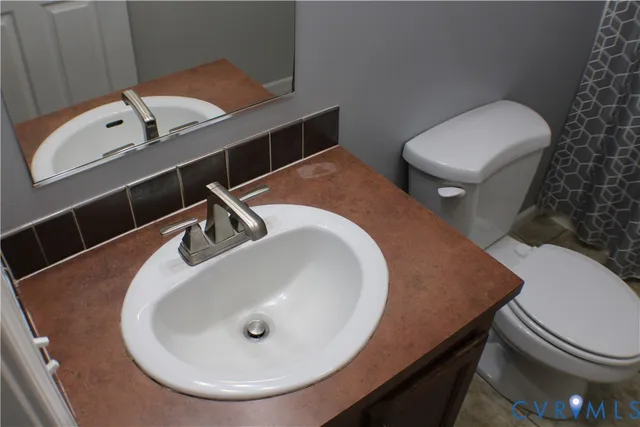 a bathroom with a toilet and a sink
