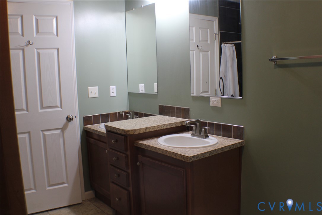 1811 Halls Store Road Mineral, VA 23117 - Photo 32 of 39 Bathroom with vanity, curtained shower, and light