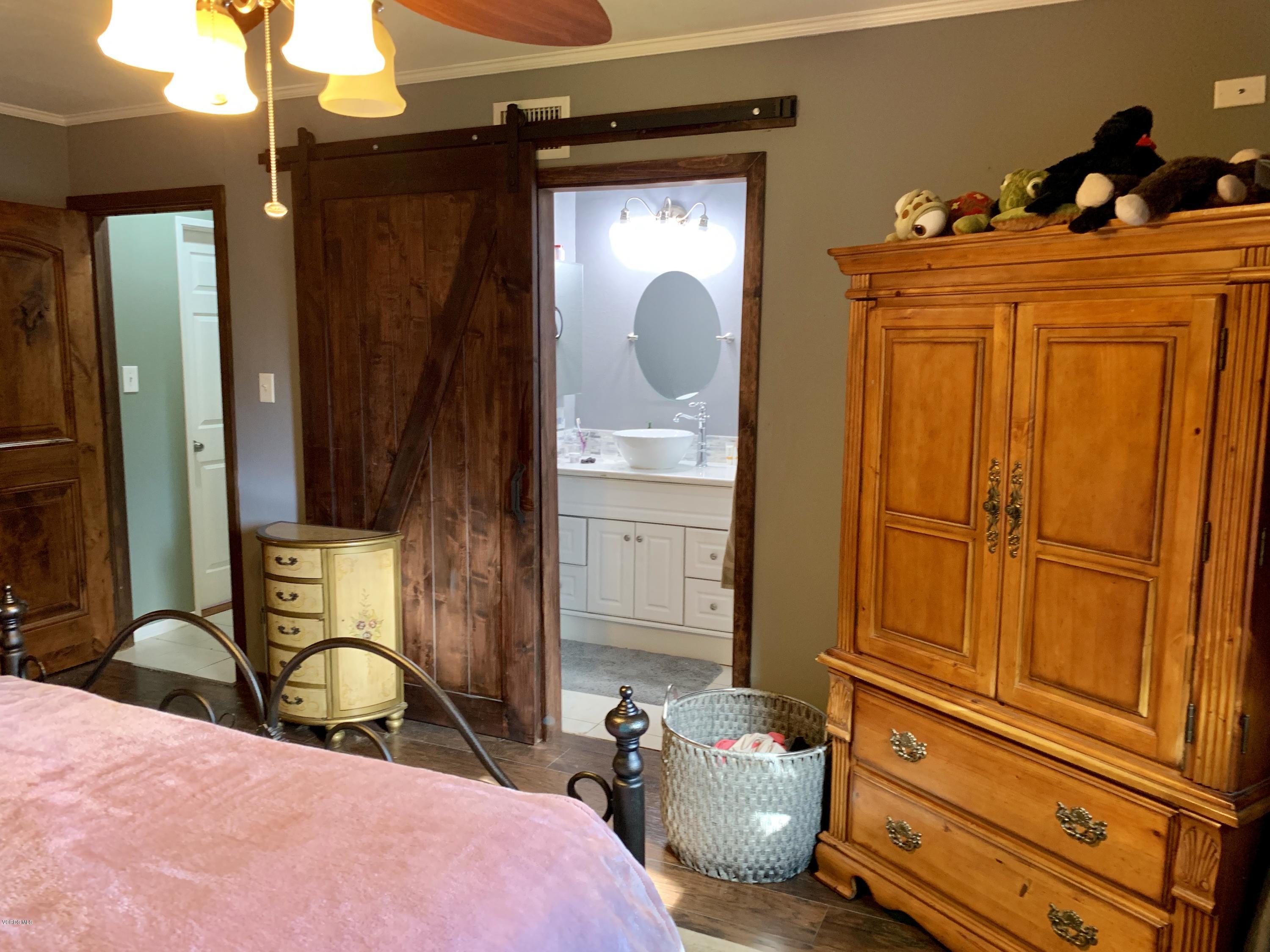 2890 Fitzgerald Road Simi Valley, CA 93065 - Photo 24 of 40 a bedroom with a bed and wooden floor