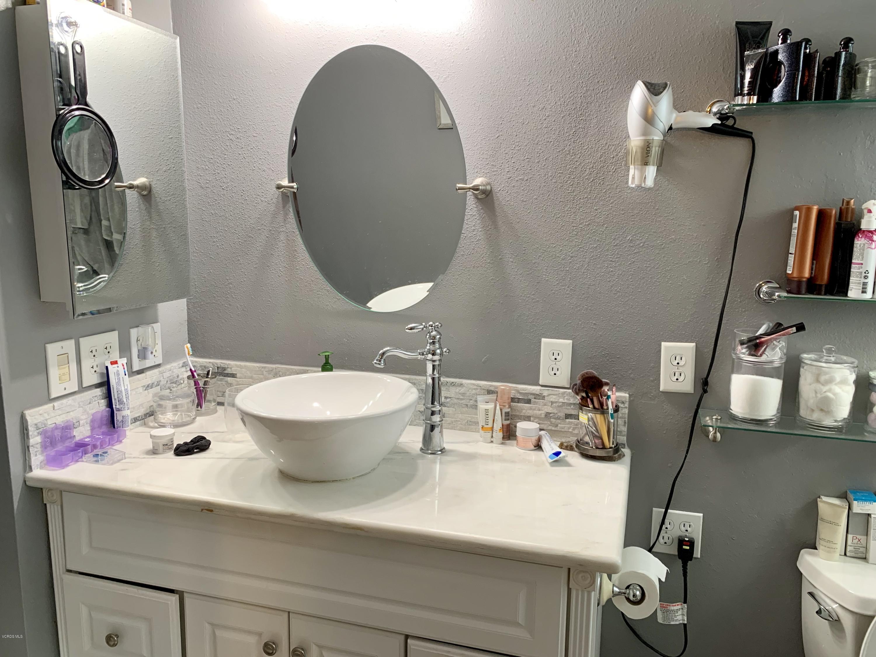 2890 Fitzgerald Road Simi Valley, CA 93065 - Photo 29 of 40 a bathroom with a sink and mirror