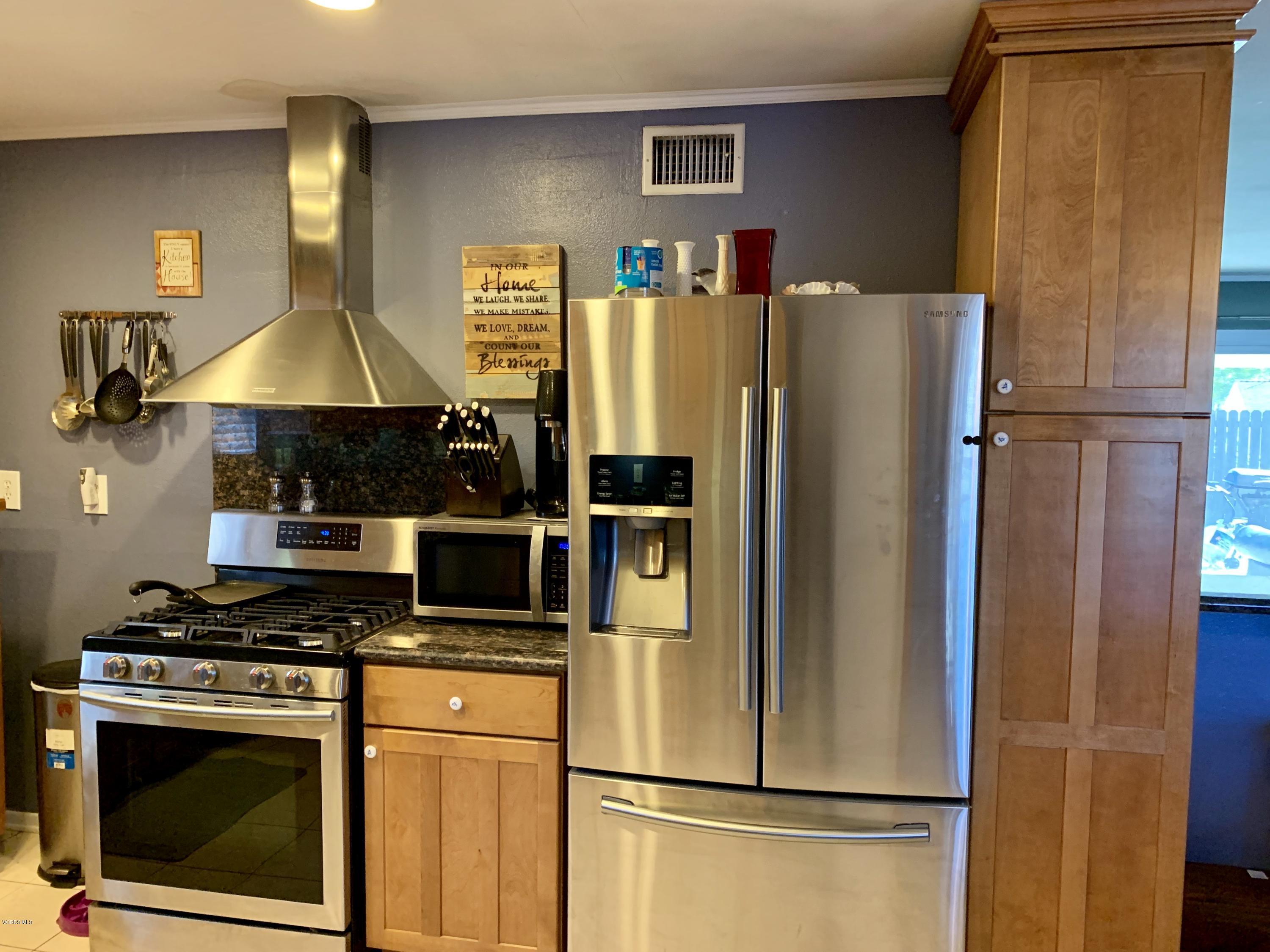 2890 Fitzgerald Road Simi Valley, CA 93065 - Photo 6 of 40 a white refrigerator freezer and a stove sitting inside of a kitchen