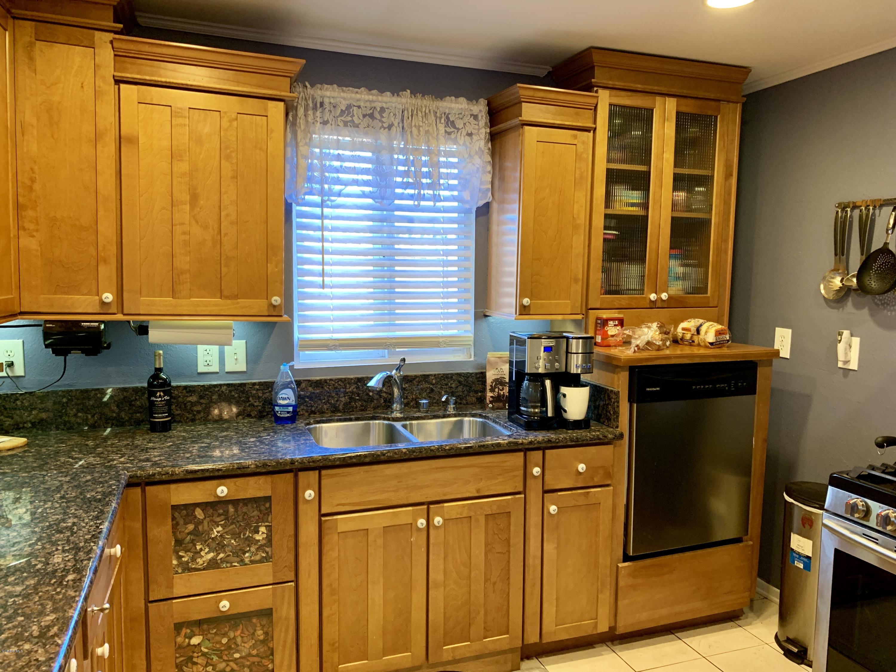 2890 Fitzgerald Road Simi Valley, CA 93065 - Photo 8 of 40 a kitchen with granite countertop sink and large window