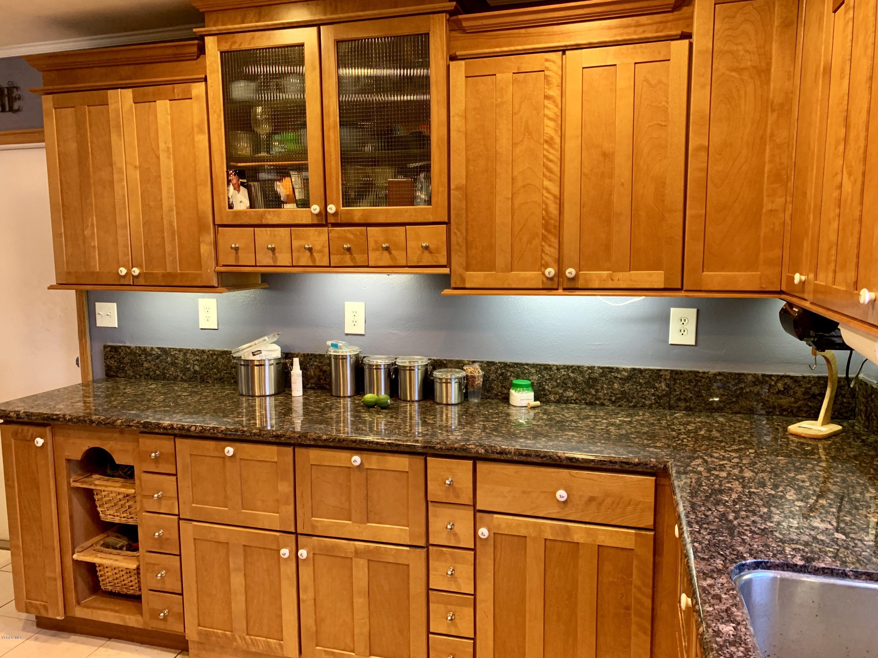 2890 Fitzgerald Road Simi Valley, CA 93065 - Photo 9 of 40 a kitchen with granite countertop sink and cabinets
