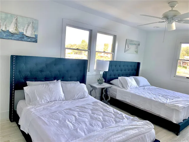 a bedroom with two beds and a chandelier