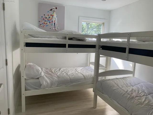 a bed sitting in a bedroom next to a window