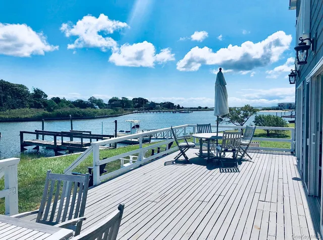 a view of a balcony with wooden chairs