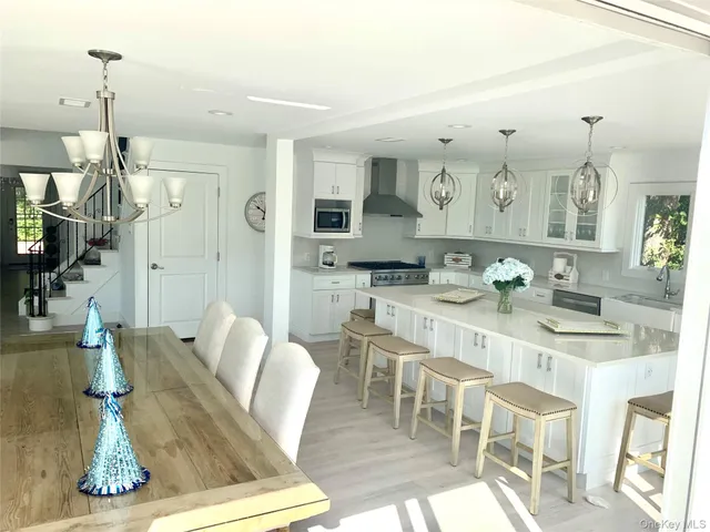 a large kitchen with a table and chairs