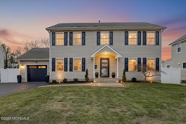 a front view of a house with a yard and porch