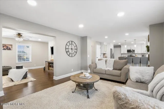 a living room with furniture kitchen view and a table