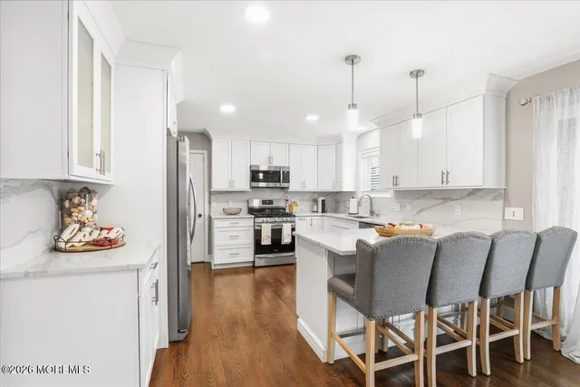 a view of kitchen with cabinets and wooden floor