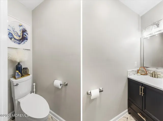 a bathroom with a toilet a sink and mirror