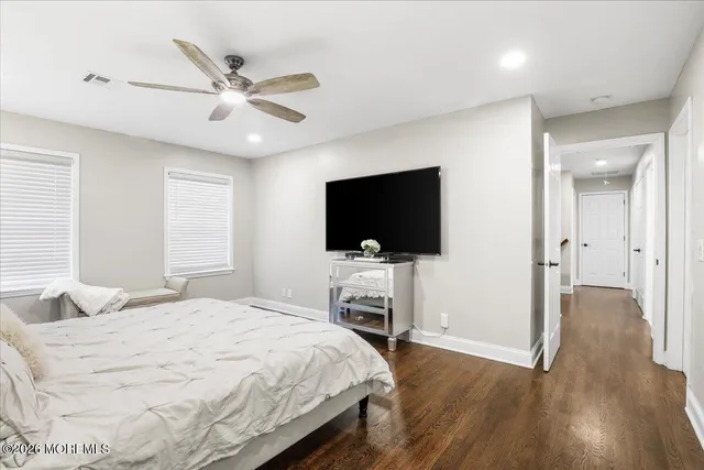 a bedroom with a flat screen television and a bed