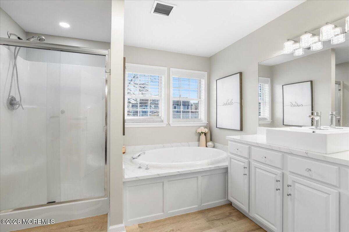 25 Community Place Long Branch, NJ 07740 - Photo 19 of 35 a bathroom with a tub a sink and mirror