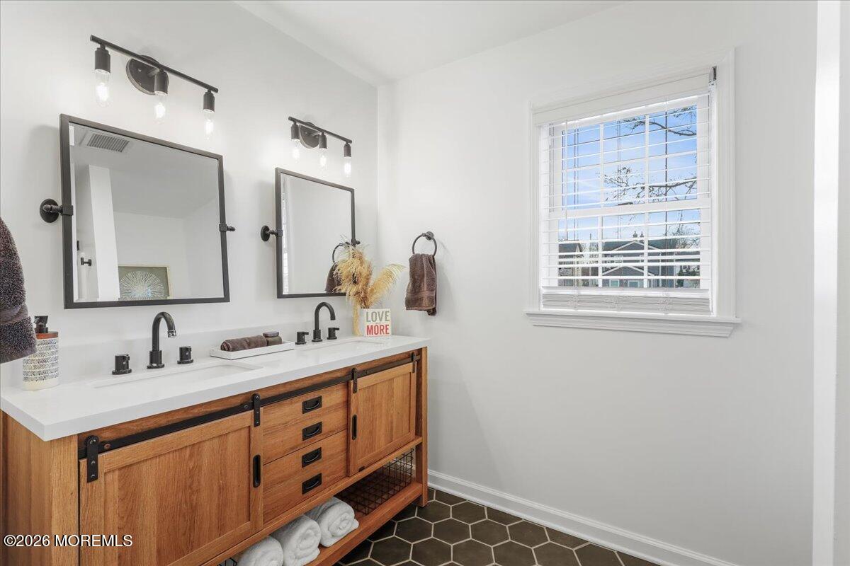 25 Community Place Long Branch, NJ 07740 - Photo 21 of 35 a bathroom with a sink a vanity and a mirror