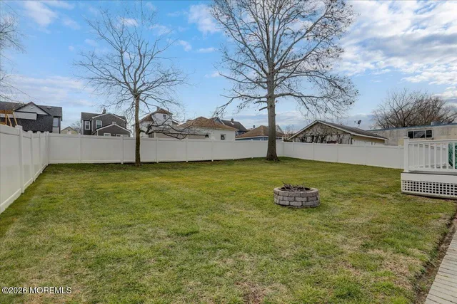 a view of yard with swimming pool and trees