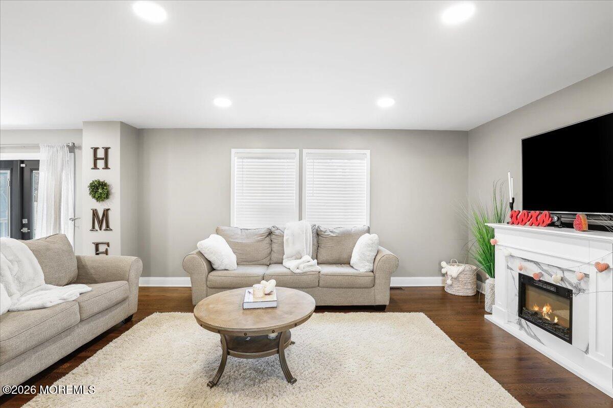 25 Community Place Long Branch, NJ 07740 - Photo 10 of 35 a living room with furniture a flat screen tv and a fireplace