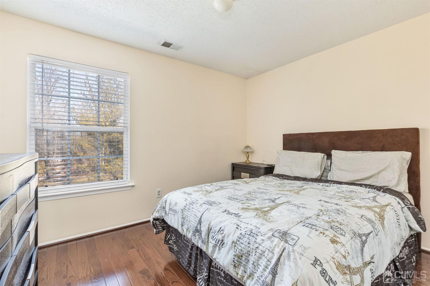 209 Nebula Road Piscataway, NJ 08854 - Photo 14 of 17 a bedroom with a bed and wooden floor