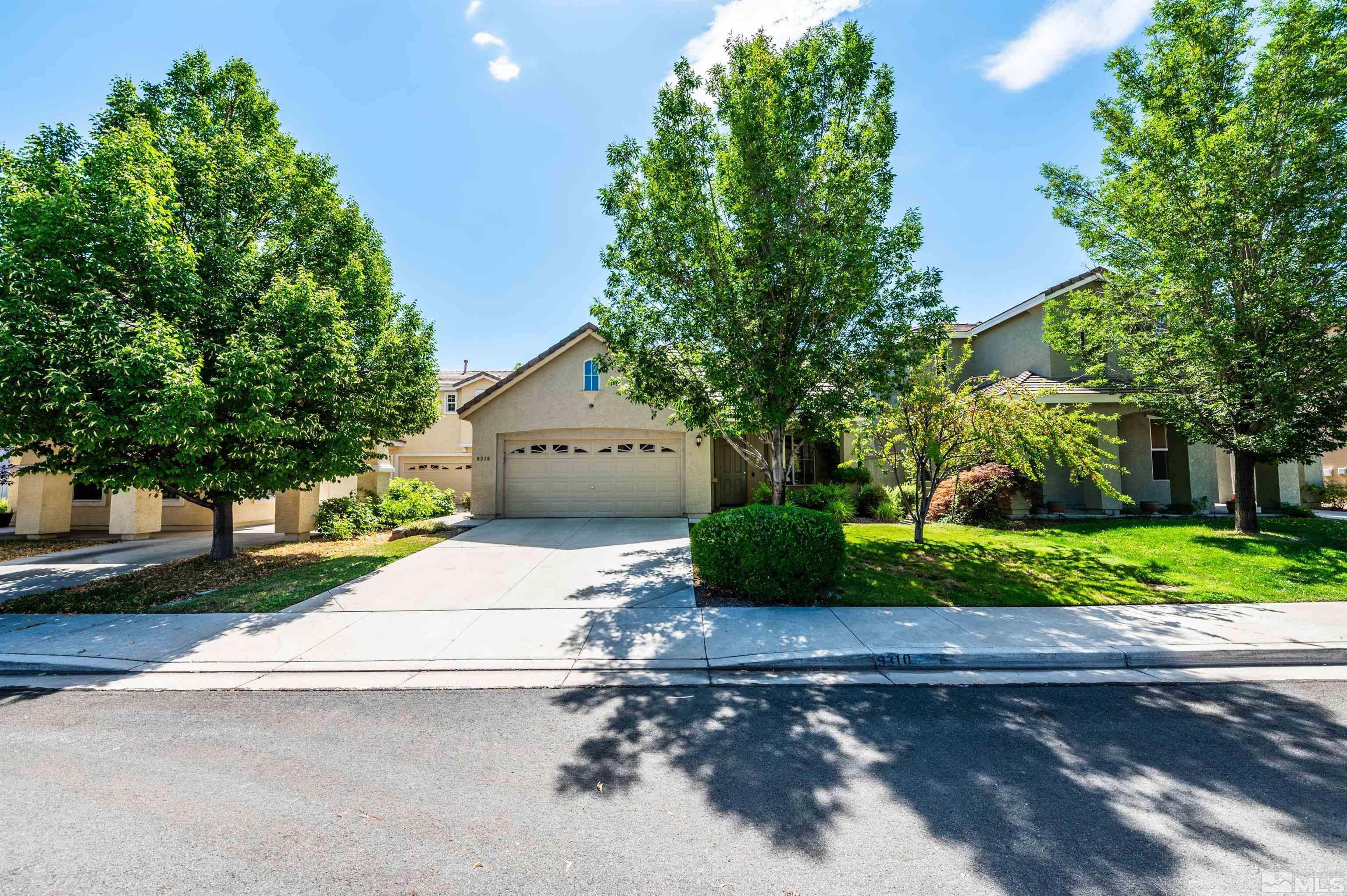 9310 Hummer Court Reno, NV 89521 - Photo 1 of 1 a front view of a house with a yard and a garden