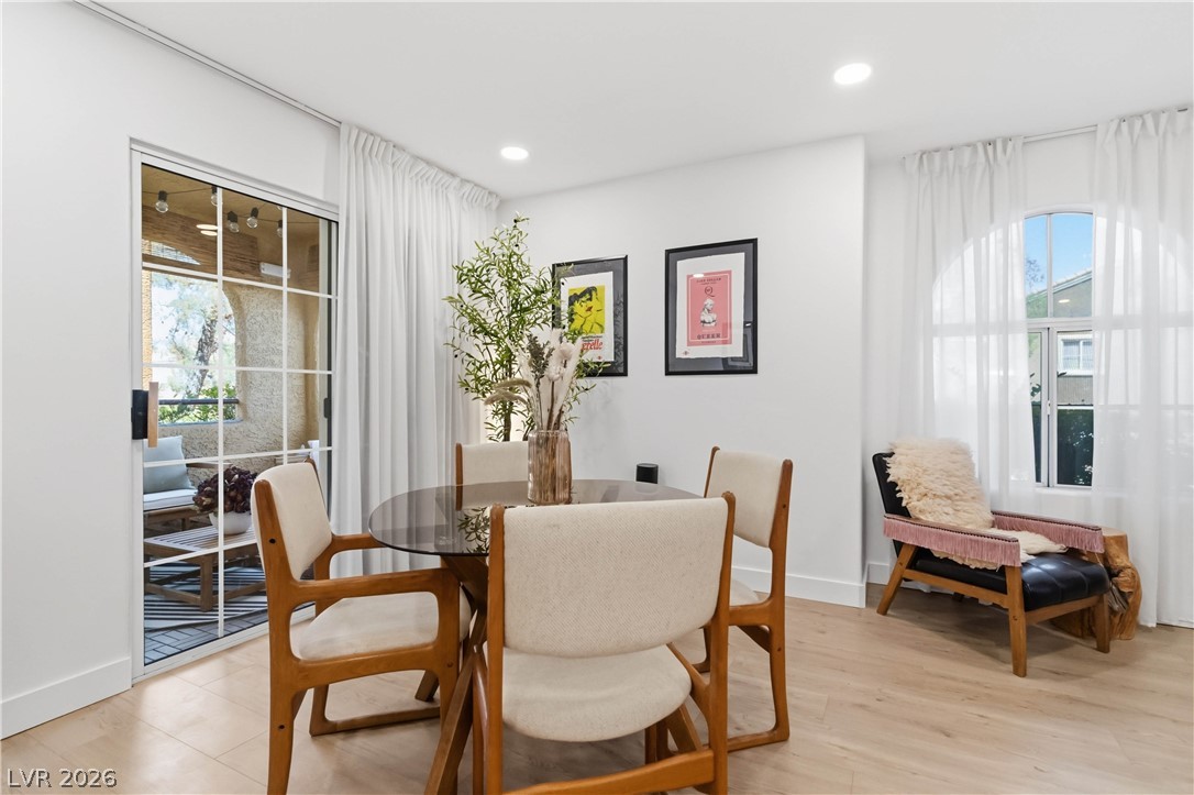 7950 West Flamingo Road, Unit 1180 Las Vegas, NV 89147 - Photo 10 of 26 An inviting dining area offers seamless indoor-outdoor living with a glass slider opening to a charming patio.