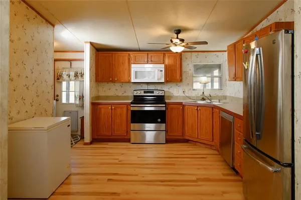 a kitchen with a stove sink and refrigerator
